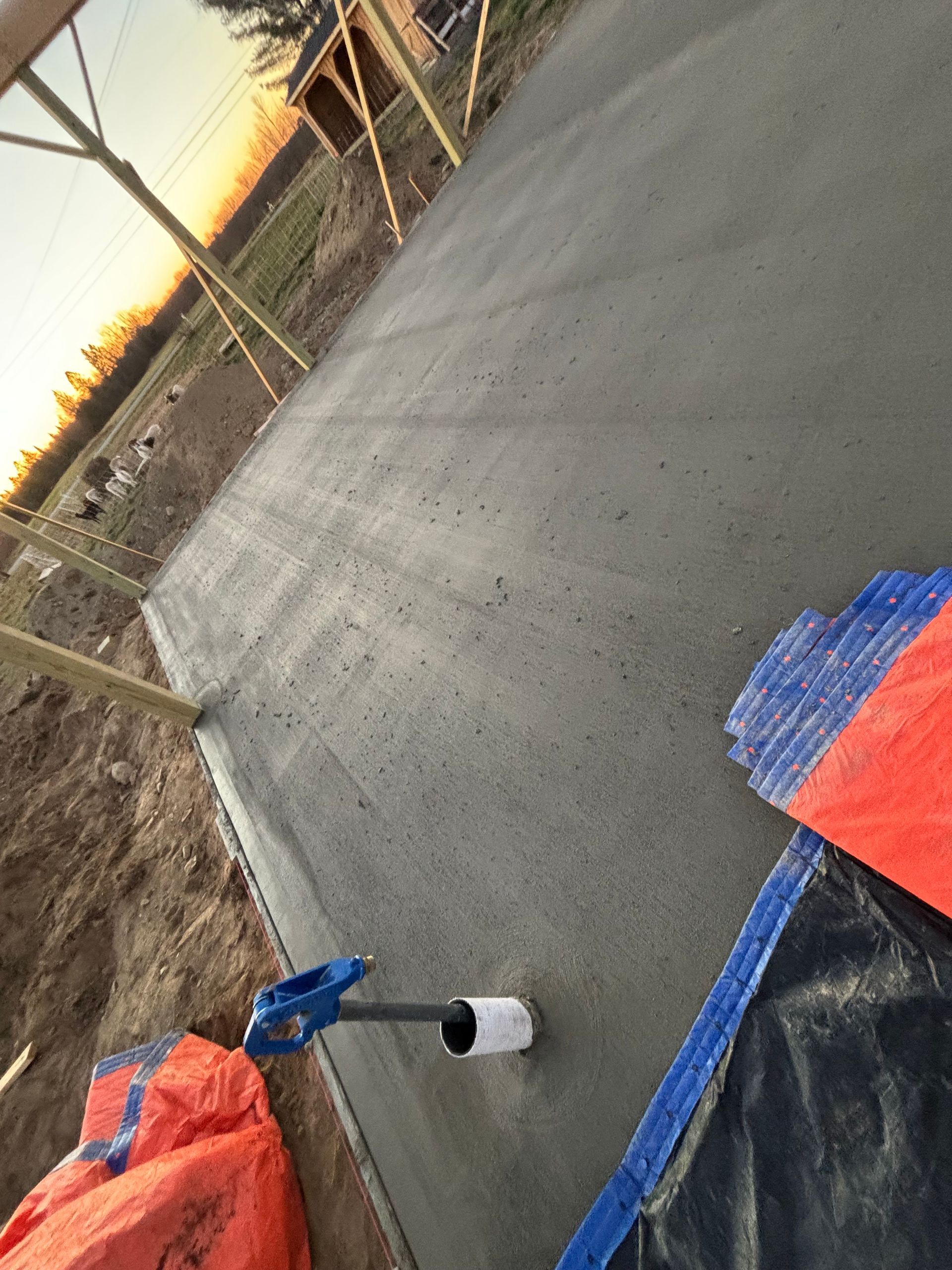 A shovel is sitting on top of a concrete surface.