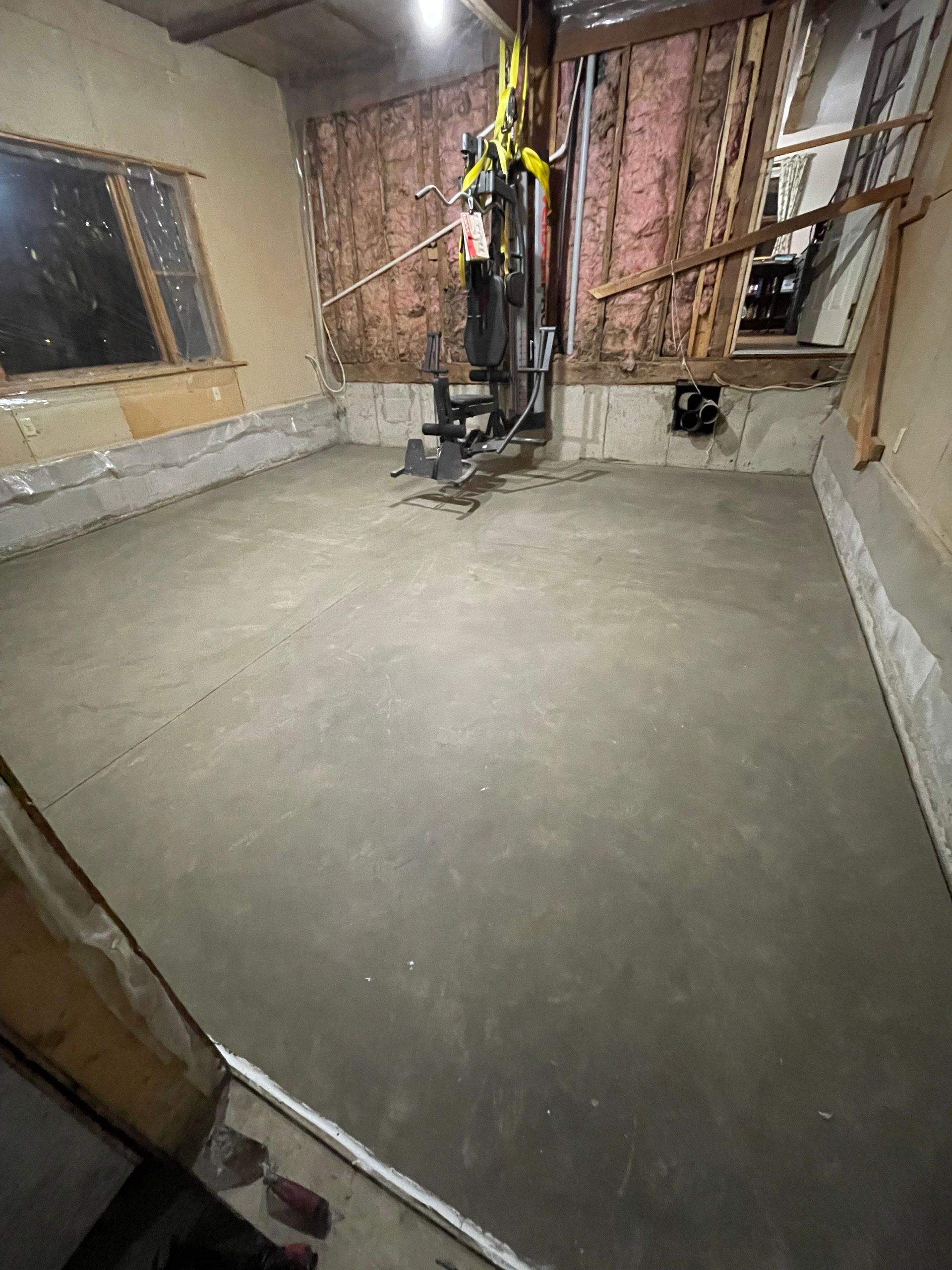 There is a gym machine in the middle of the room.