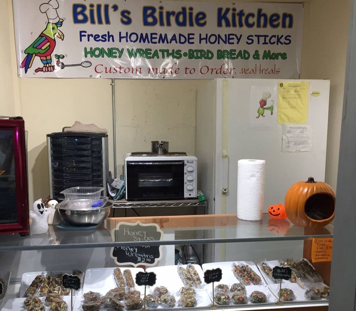 A large fish tank is sitting in a store next to a sign that says aquasky.