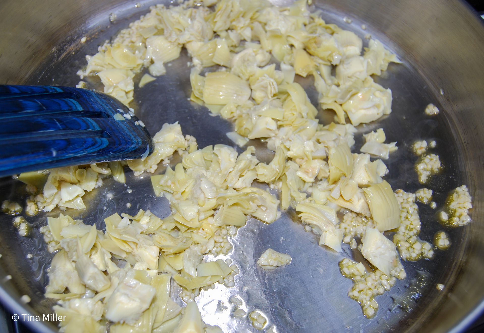 chopped artichoke hearts and garlic sautéing in extra virgin olive oil.