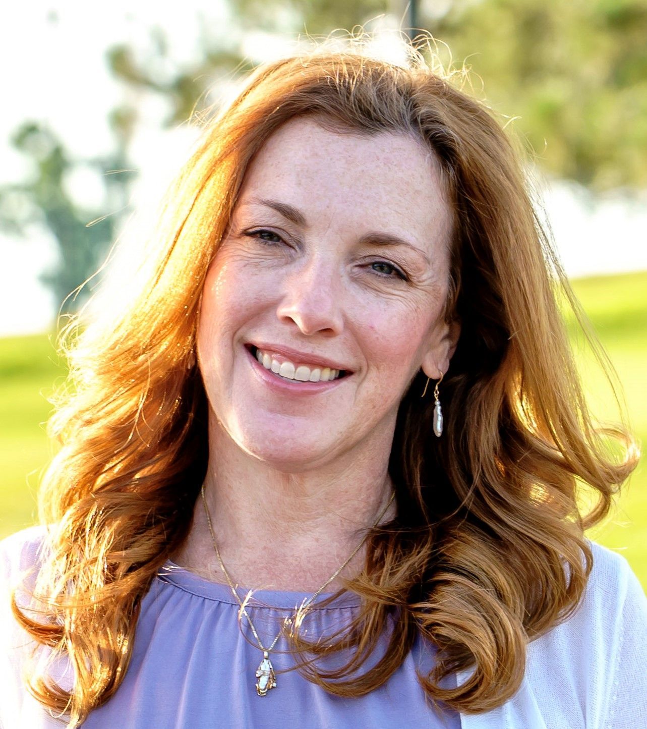 Tina Miller headshot with long red hair