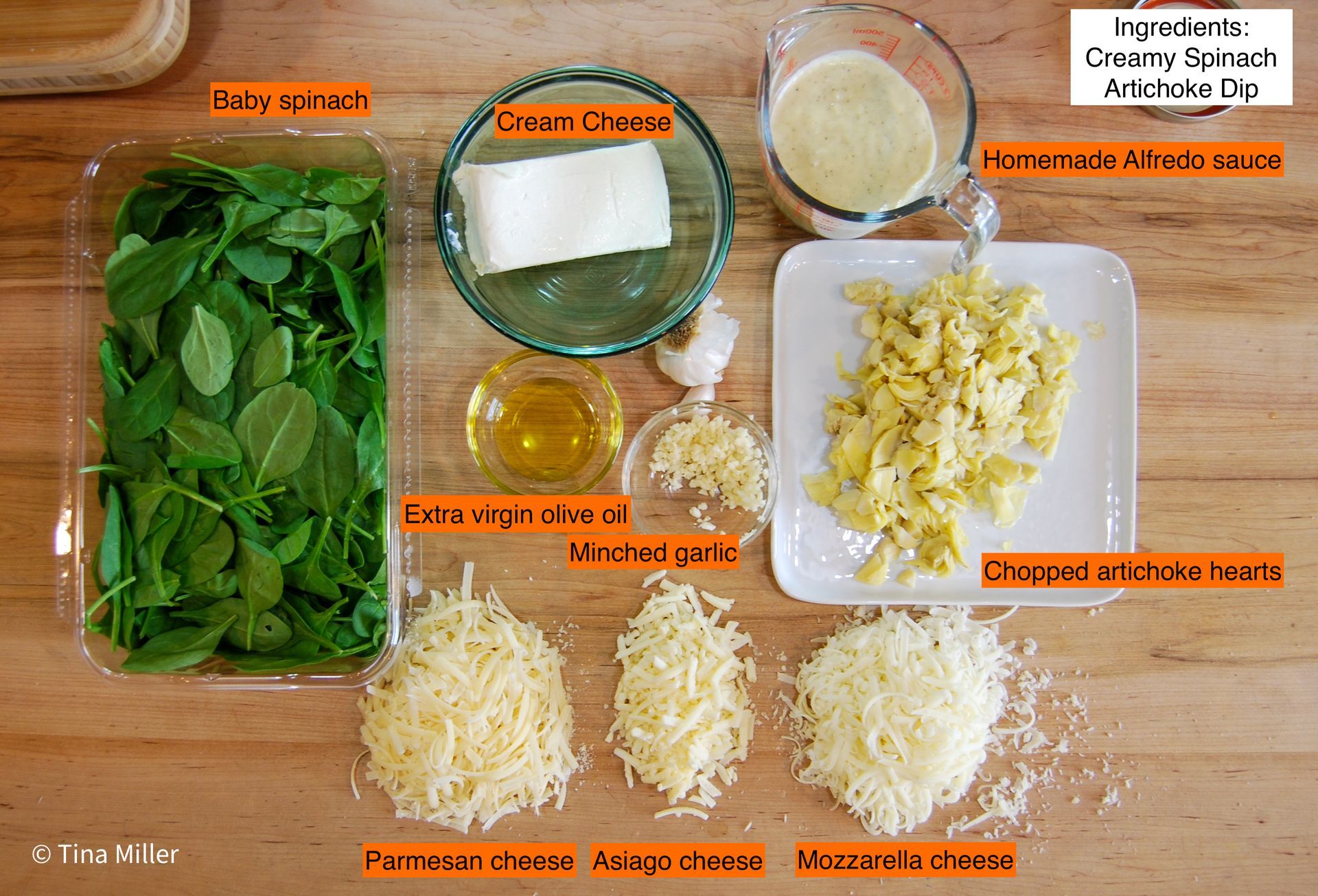 Ingredients for making spinach and artichoke dip including spinach, cream cheese, and homemade Alfredo sauce.