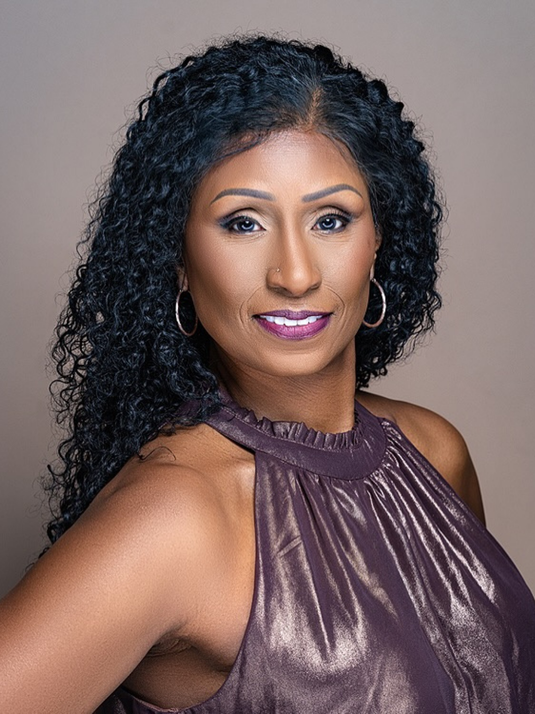 Needle injecting into skin near neck and ear of a person with blonde hair.