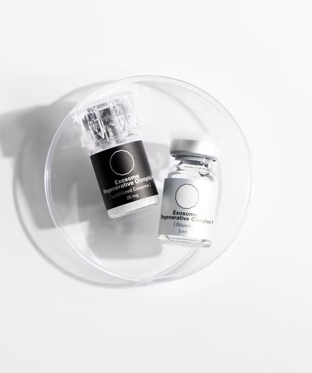 Two glass vials with white labels and black circle accents on a white surface.