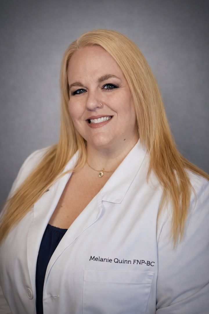 Needle injecting into skin near neck and ear of a person with blonde hair.