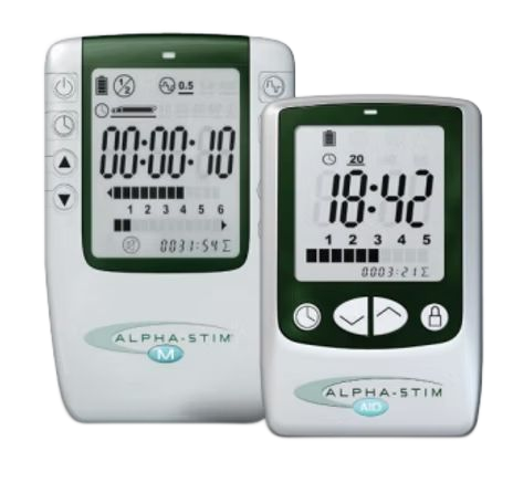 Two white Alpha-Stim medical devices, one larger with a timer, the other smaller with a clock; both have digital displays and buttons.