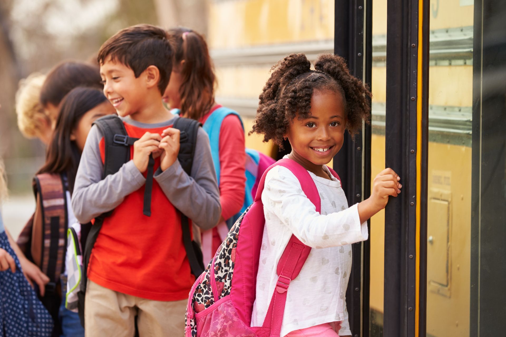A group of children are boarding a school bus.