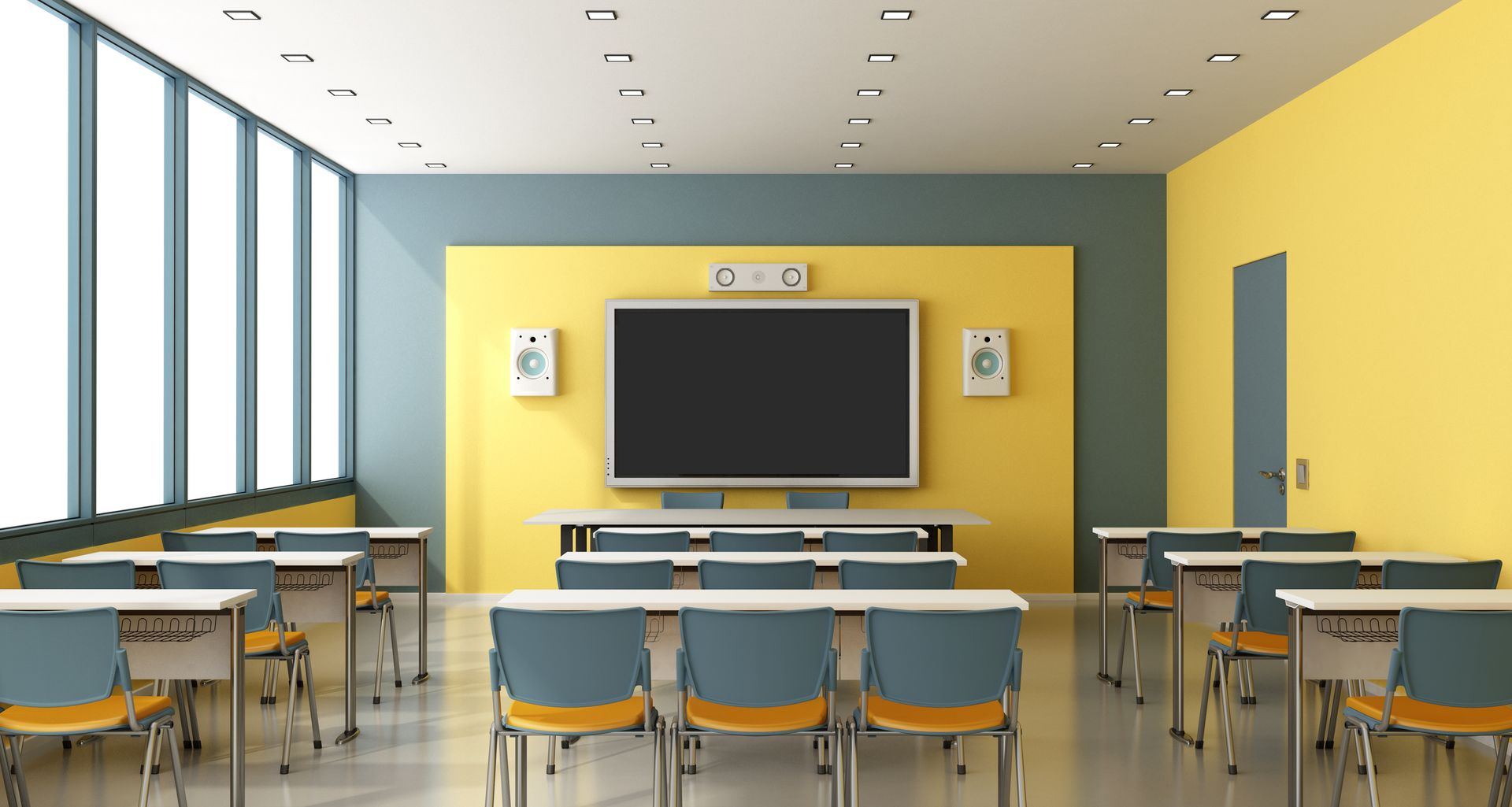 A classroom with tables and chairs and a large flat screen tv