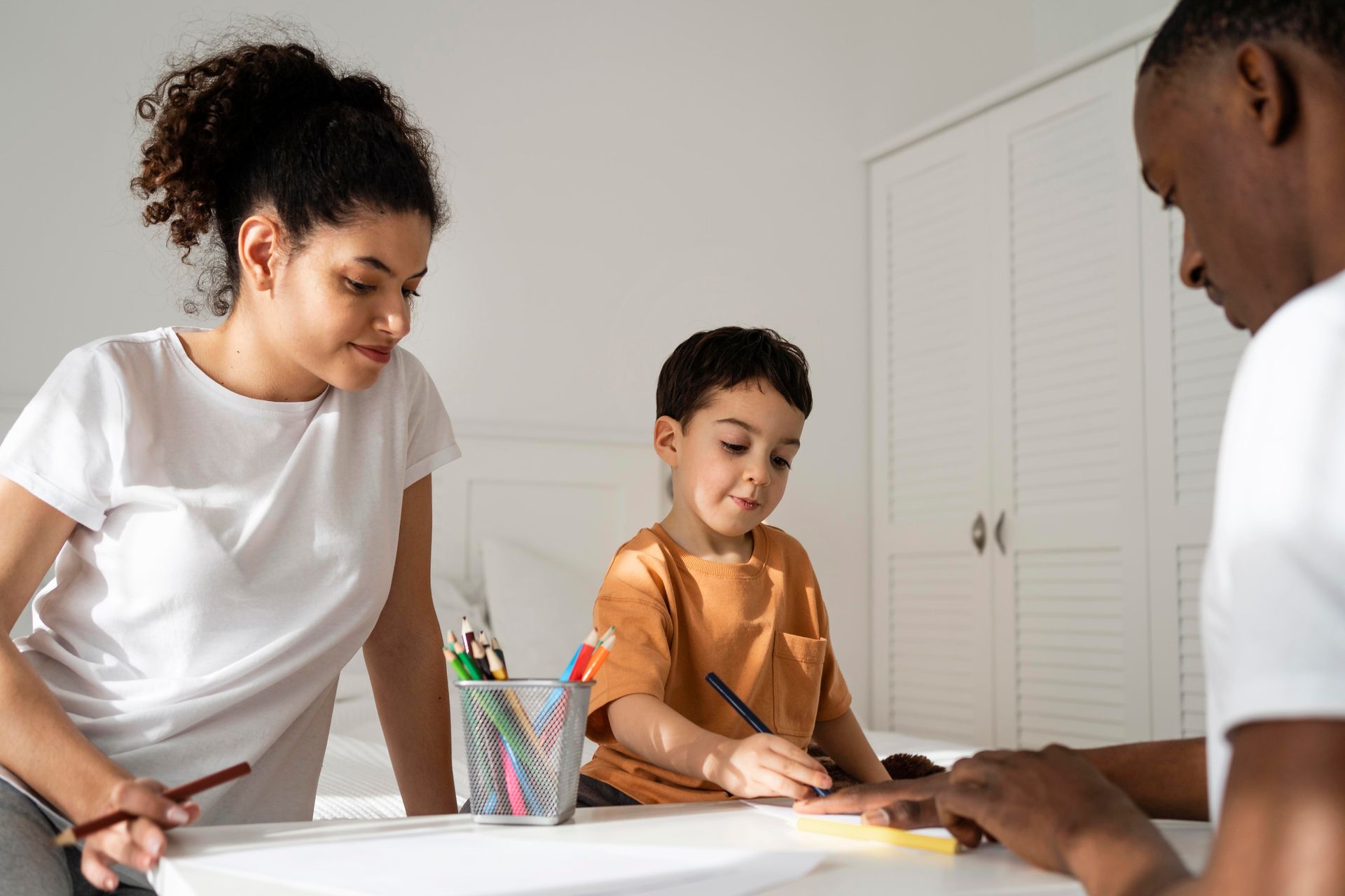 A man and a woman are sitting at a table with two children.