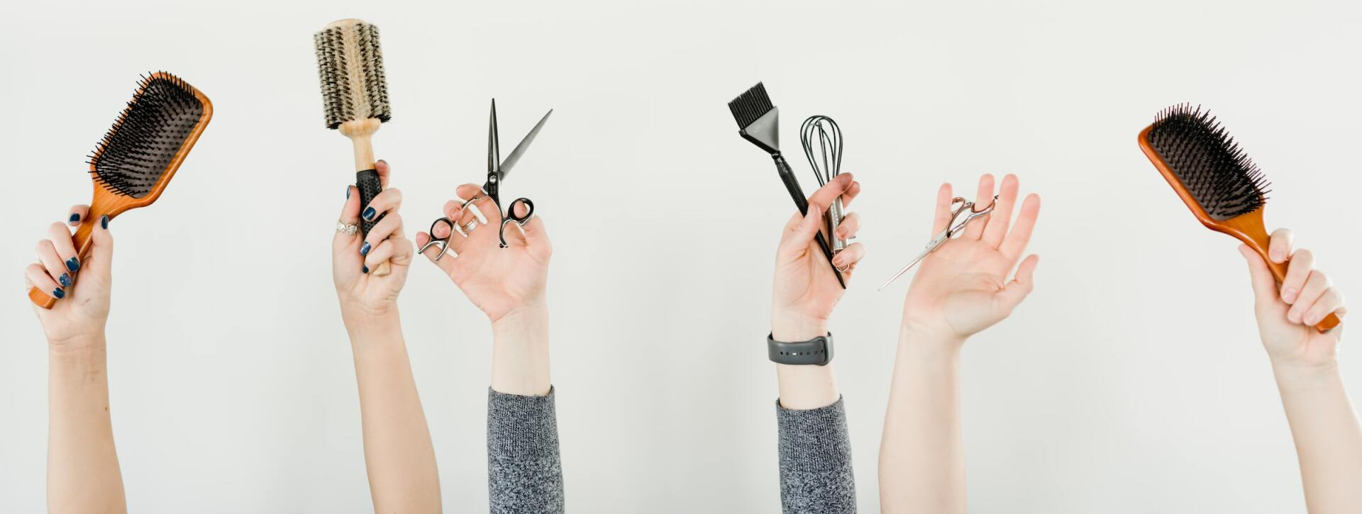 Photo of people's hands holding various hair salon items