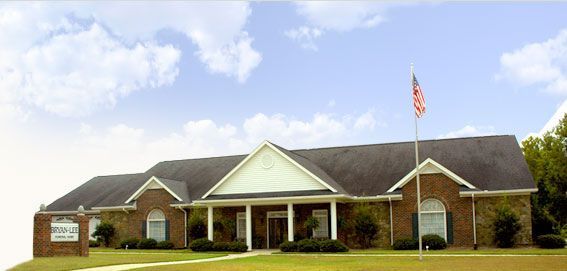 A large brick house with a flag in front of it