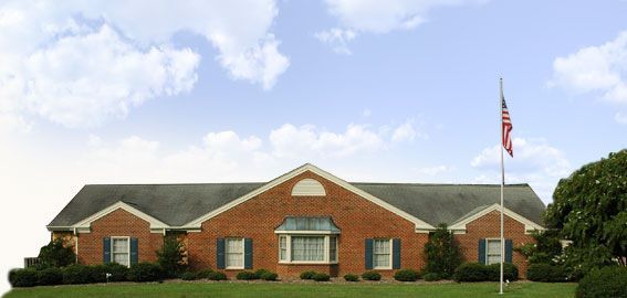 A large brick house with a flag in front of it