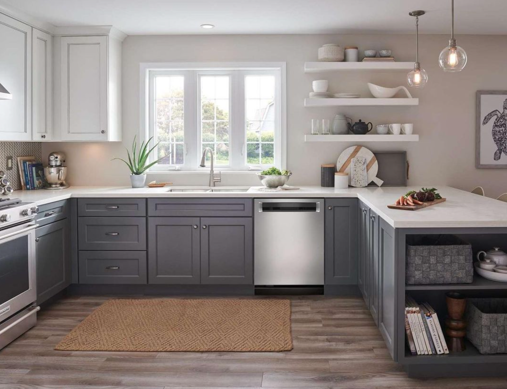 A kitchen with gray cabinets , stainless steel appliances , a sink , and a rug.