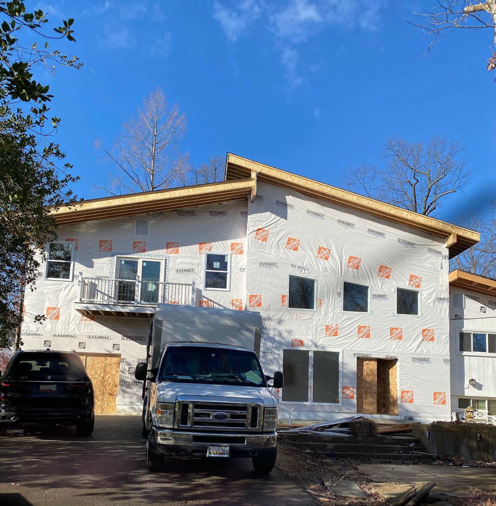 A truck is parked in front of a house under construction