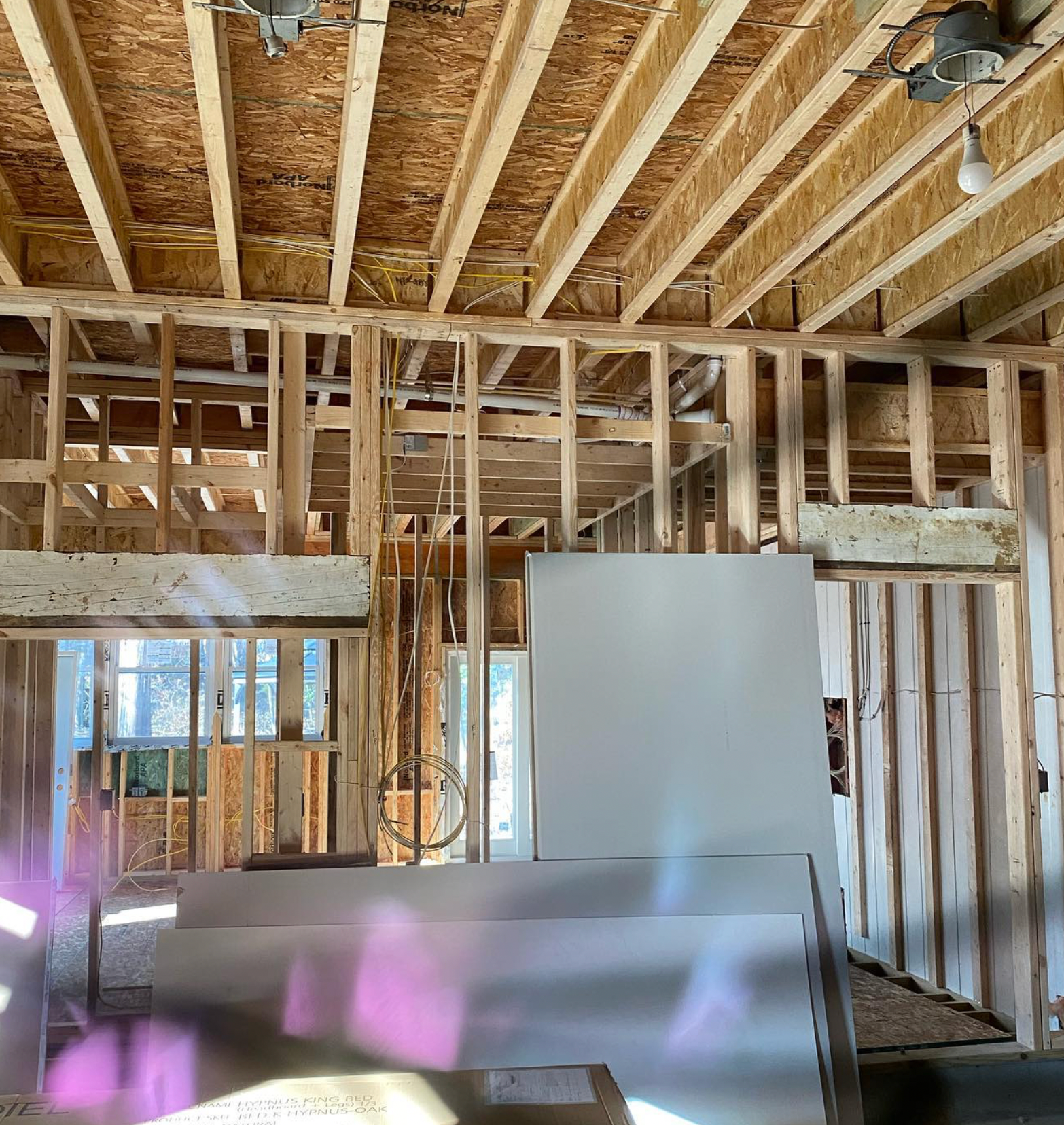 A house under construction with a ceiling fan hanging from it