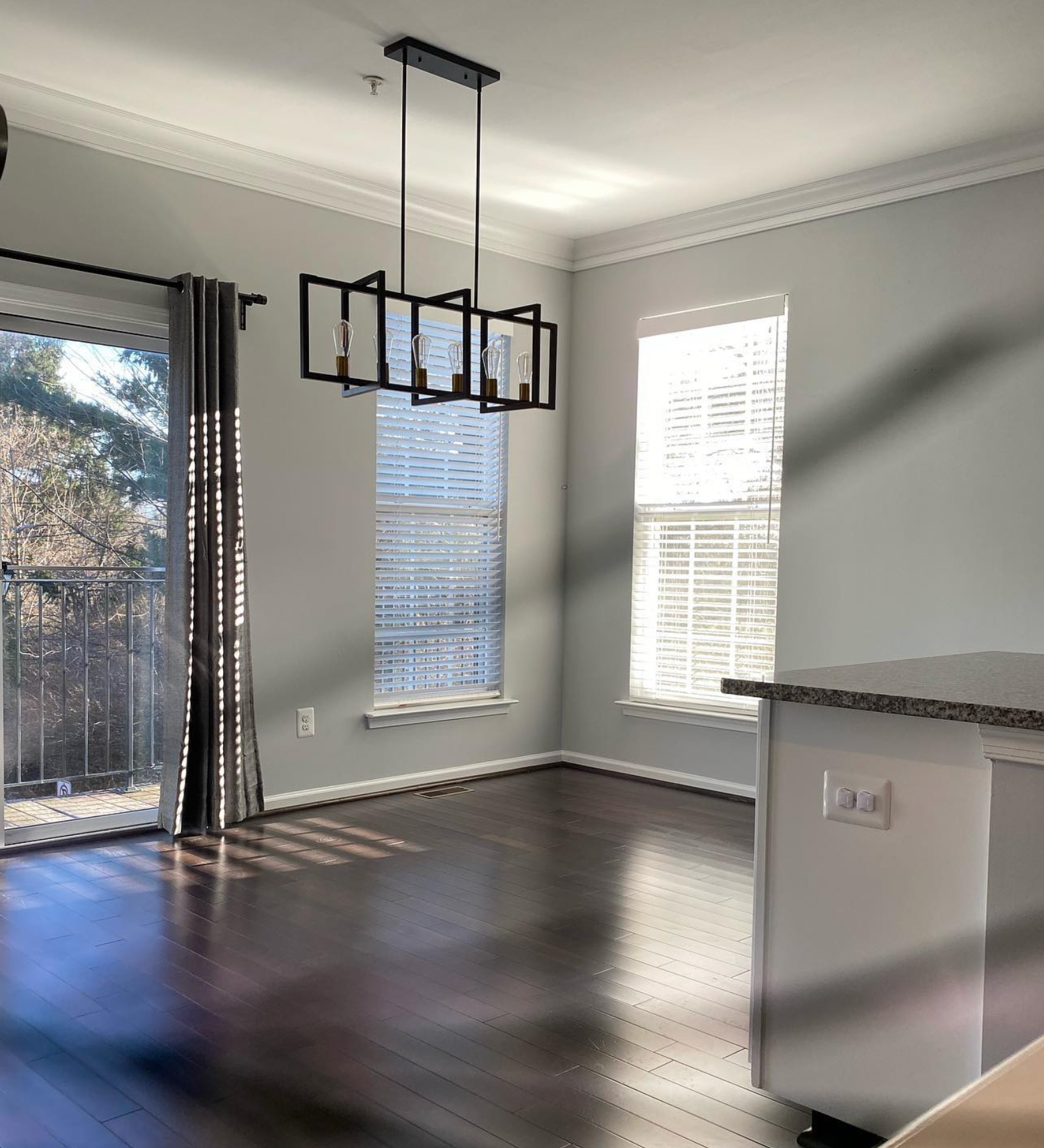 A living room with hardwood floors and a sliding glass door