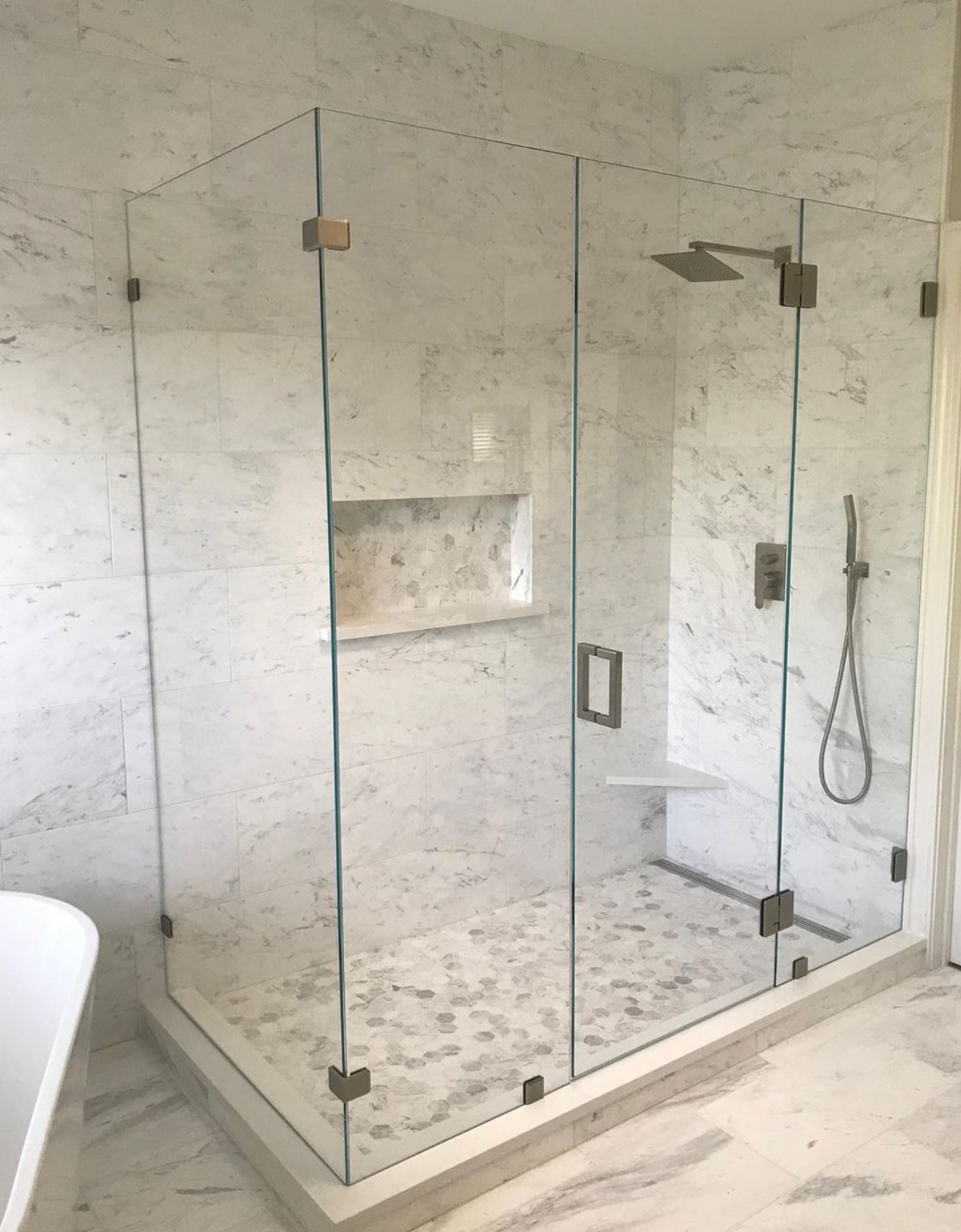 A bathroom with a walk in shower and a bathtub.