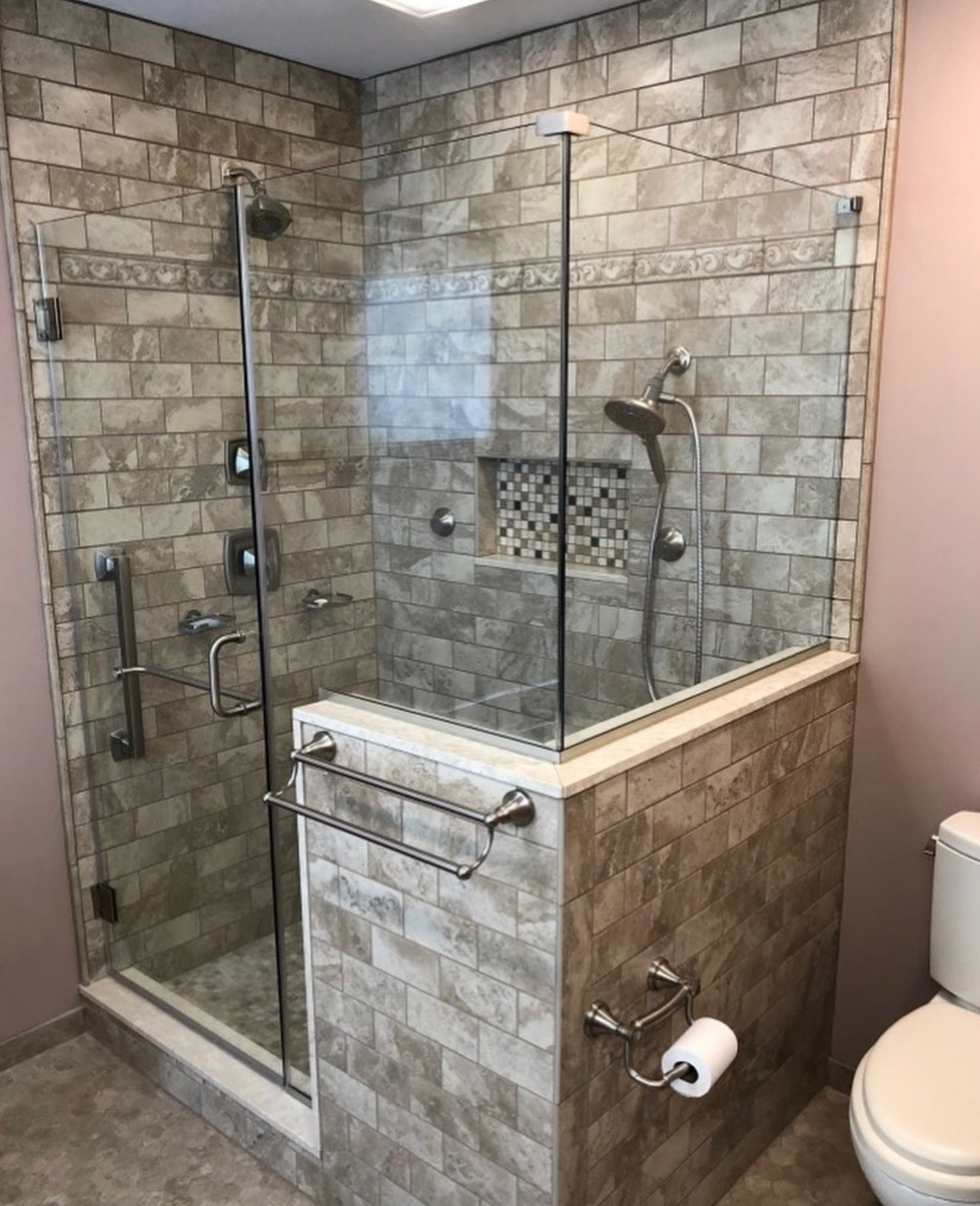 A bathroom with a walk in shower and a toilet.