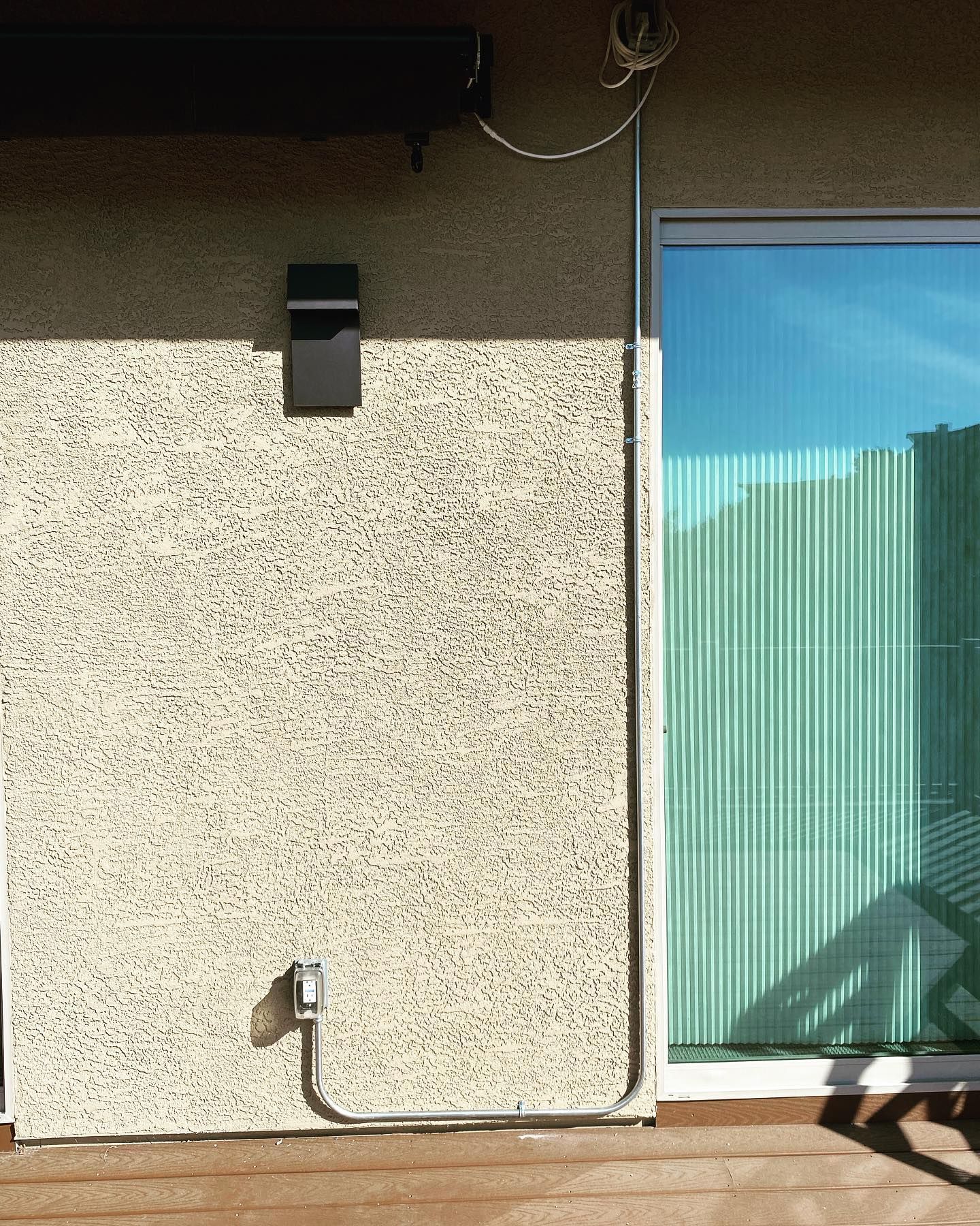 A sliding glass door is on the side of a house