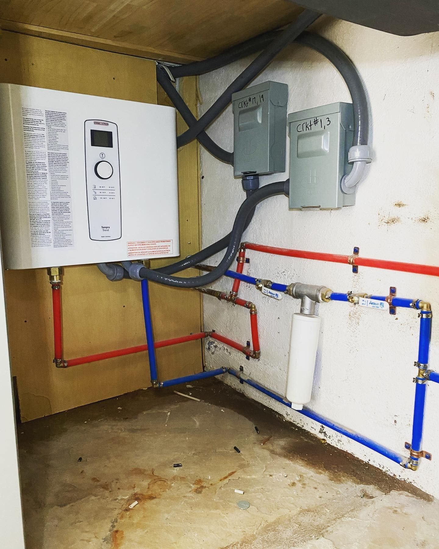 A room with a heater and a bunch of pipes