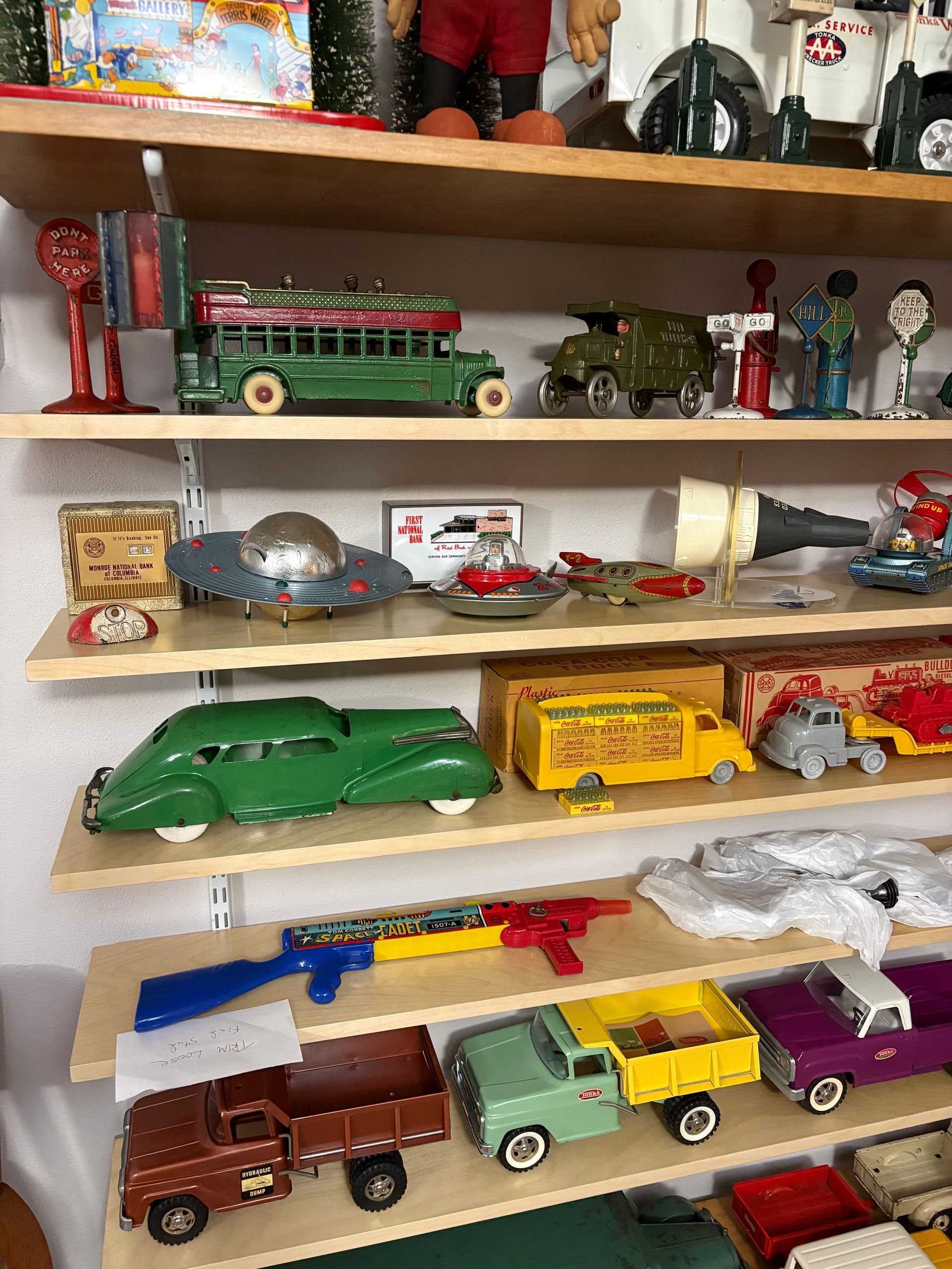 Toy car collection displayed on wooden shelves, with colorful vintage and modern models