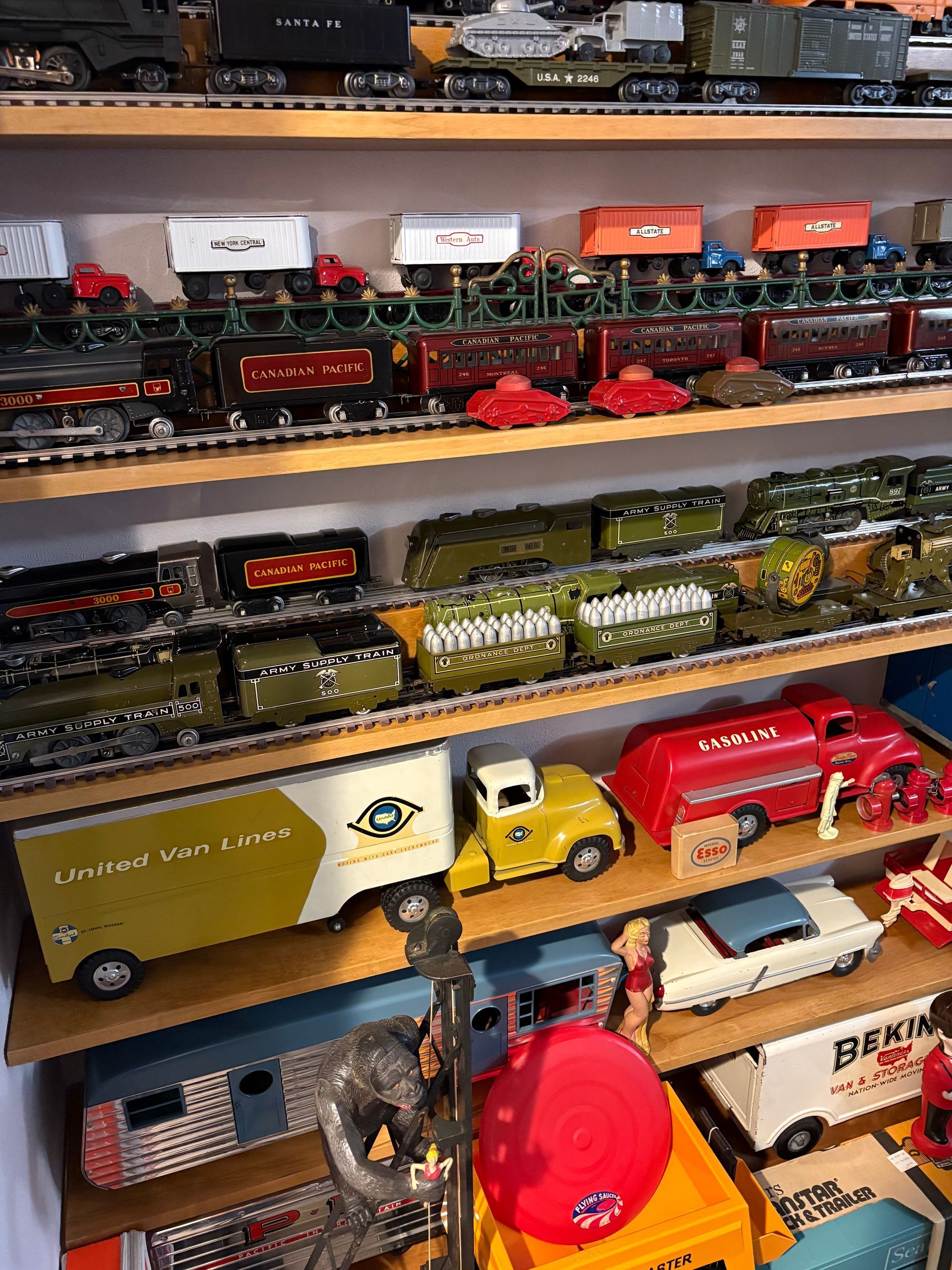 Shelves of model trucks and trucks in a display, with colorful mini vehicles and boxes stacked in rows