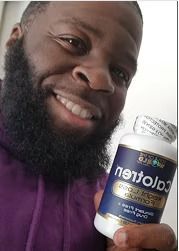 Man holding a bottle of "Caloten" supplement, smiling. Bottle is blue, white label. Man wears purple.