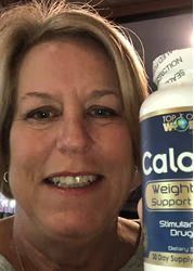 Woman holding a bottle of "Calo" weight support pills, smiling.