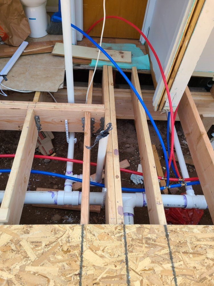 A bunch of pipes are connected to a wooden frame