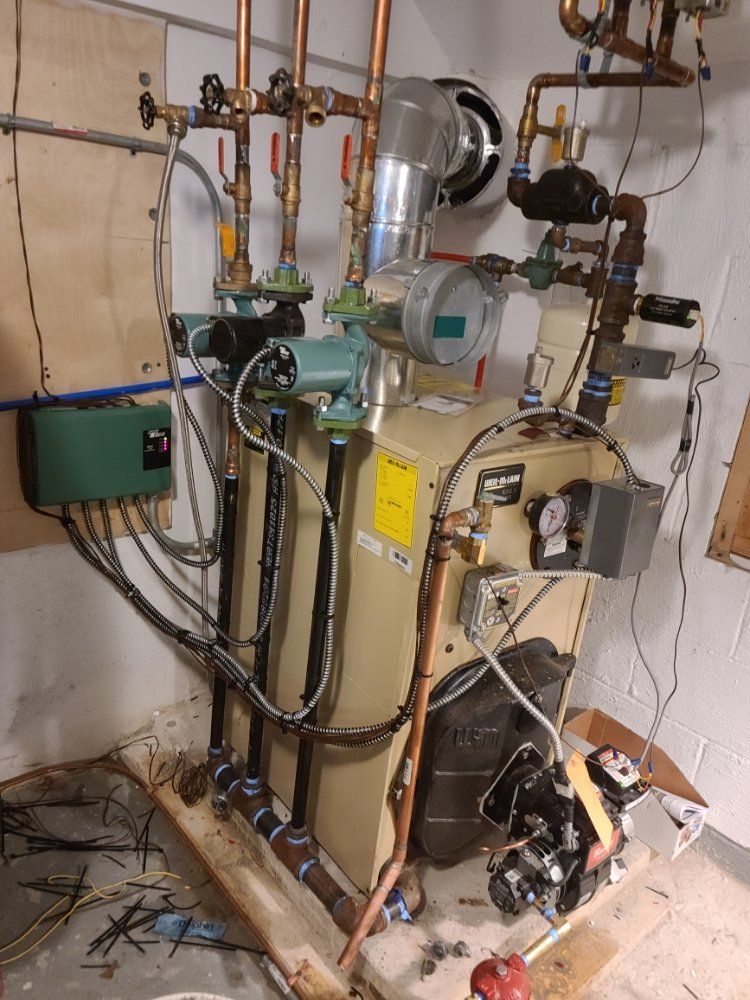 A boiler with a lot of wires coming out of it