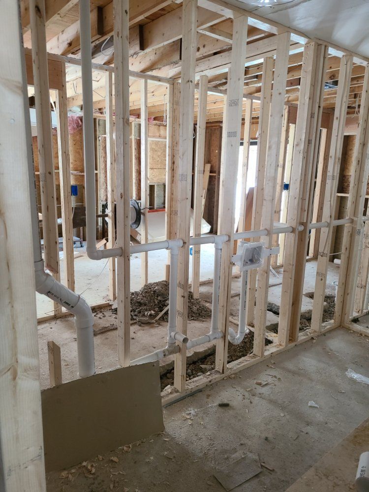 A house is being built with wooden beams and pipes.