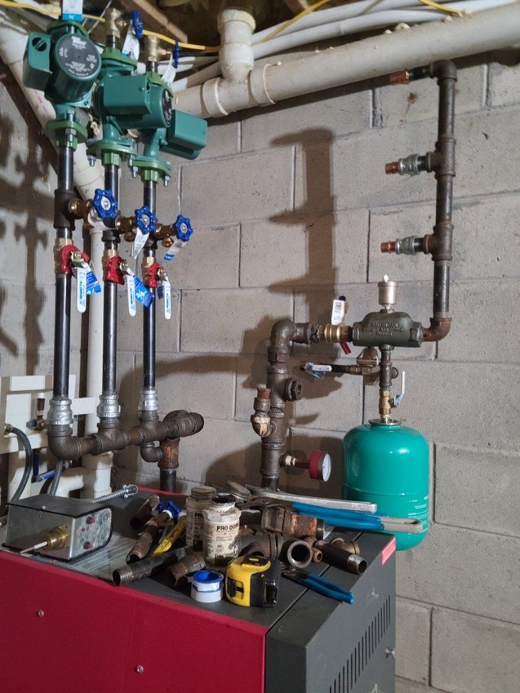 A boiler with a lot of pipes connected to it