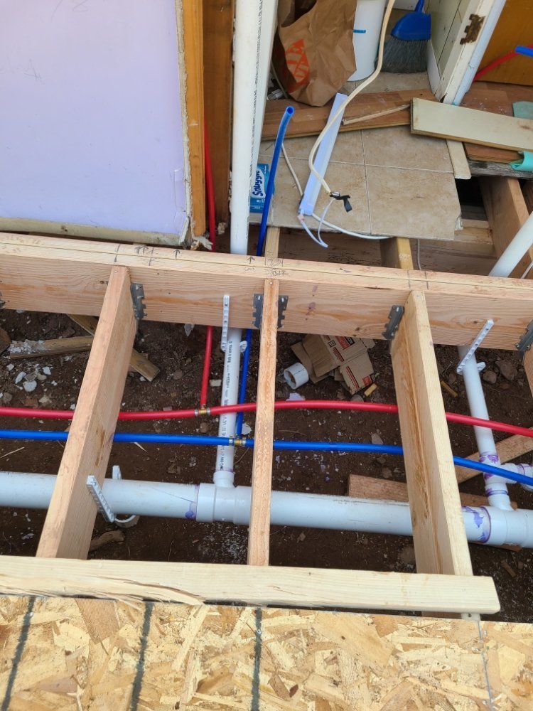 A bunch of pipes are under a wooden frame
