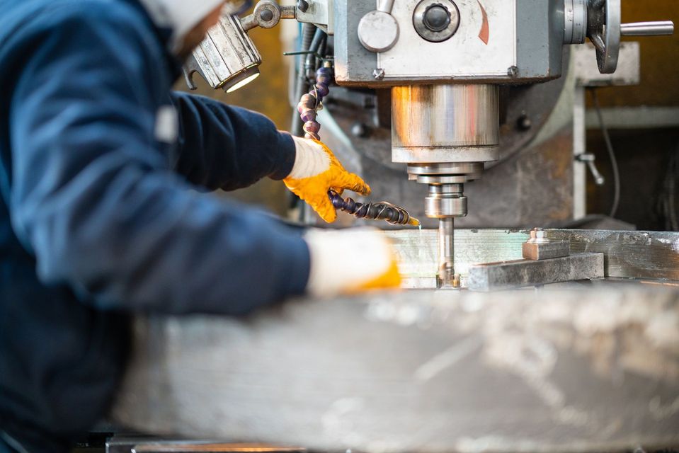 Un uomo sta lavorando a una macchina in una fabbrica.