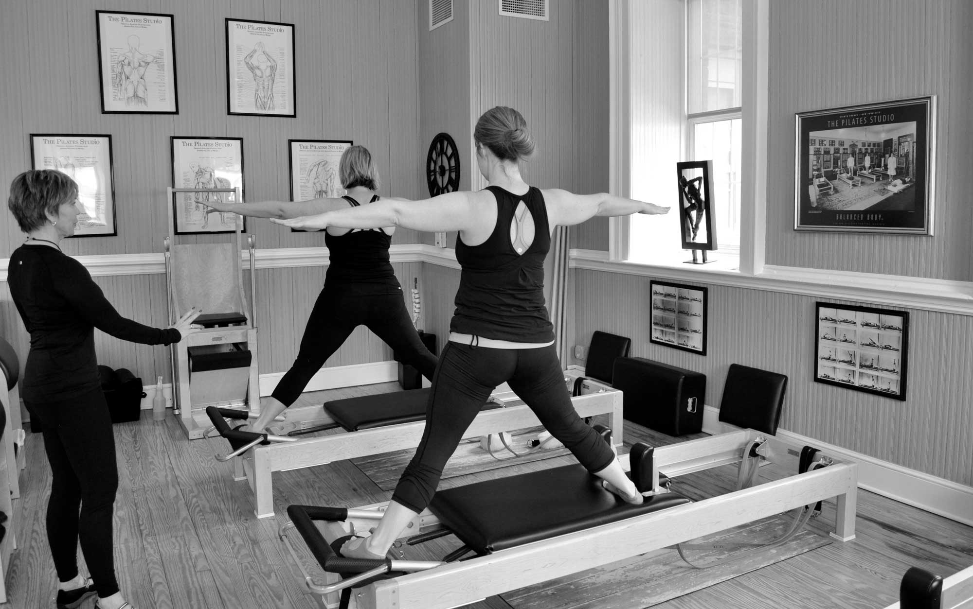 A group of women are doing Pilates on pilates machines 