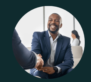 A man in a suit is shaking hands with another man