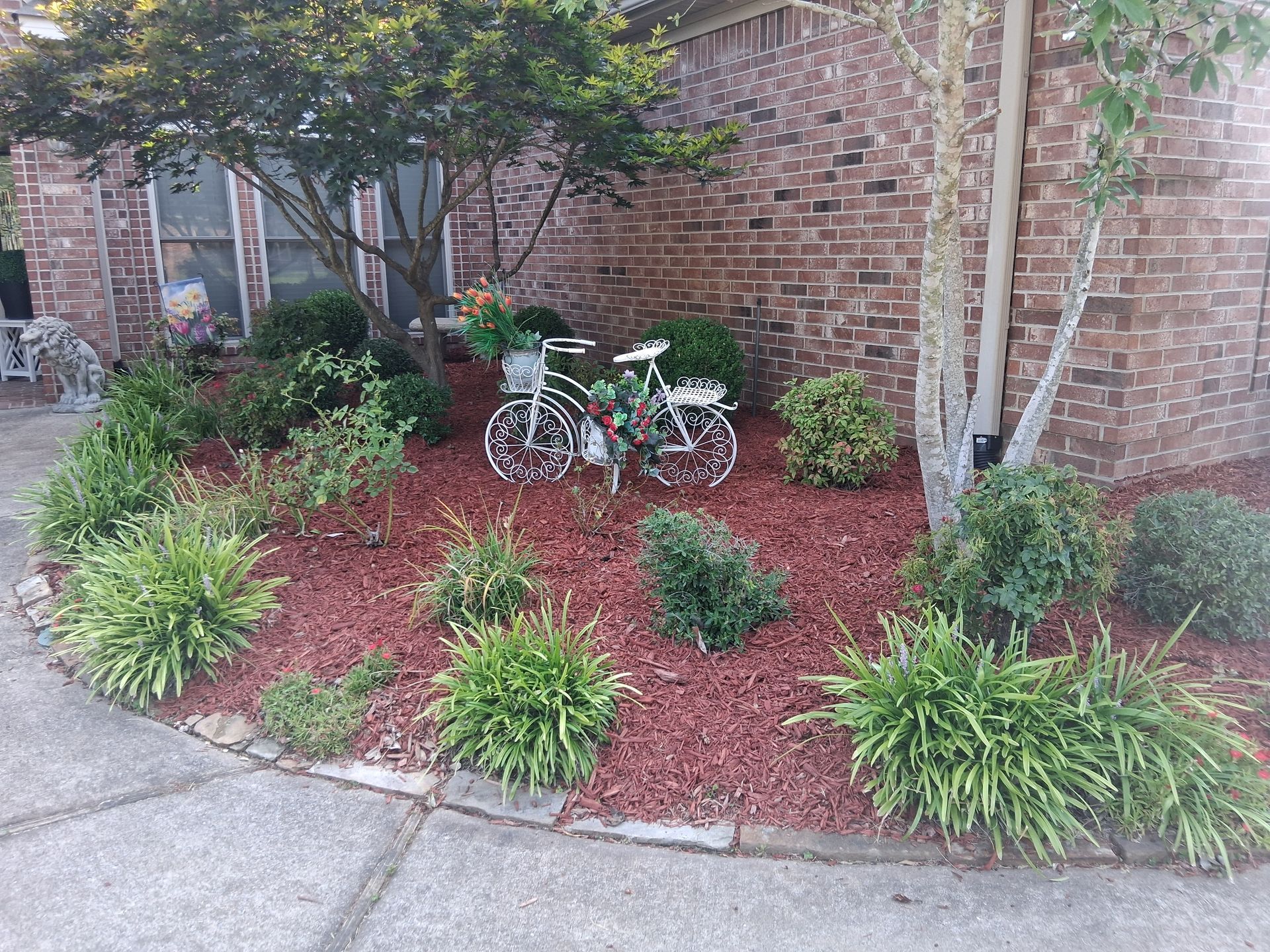 A brick house with a flower bed
