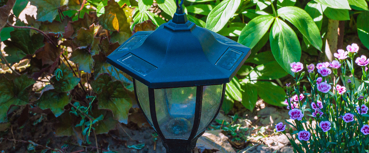 Solar-powered garden lamp with a black hexagonal top