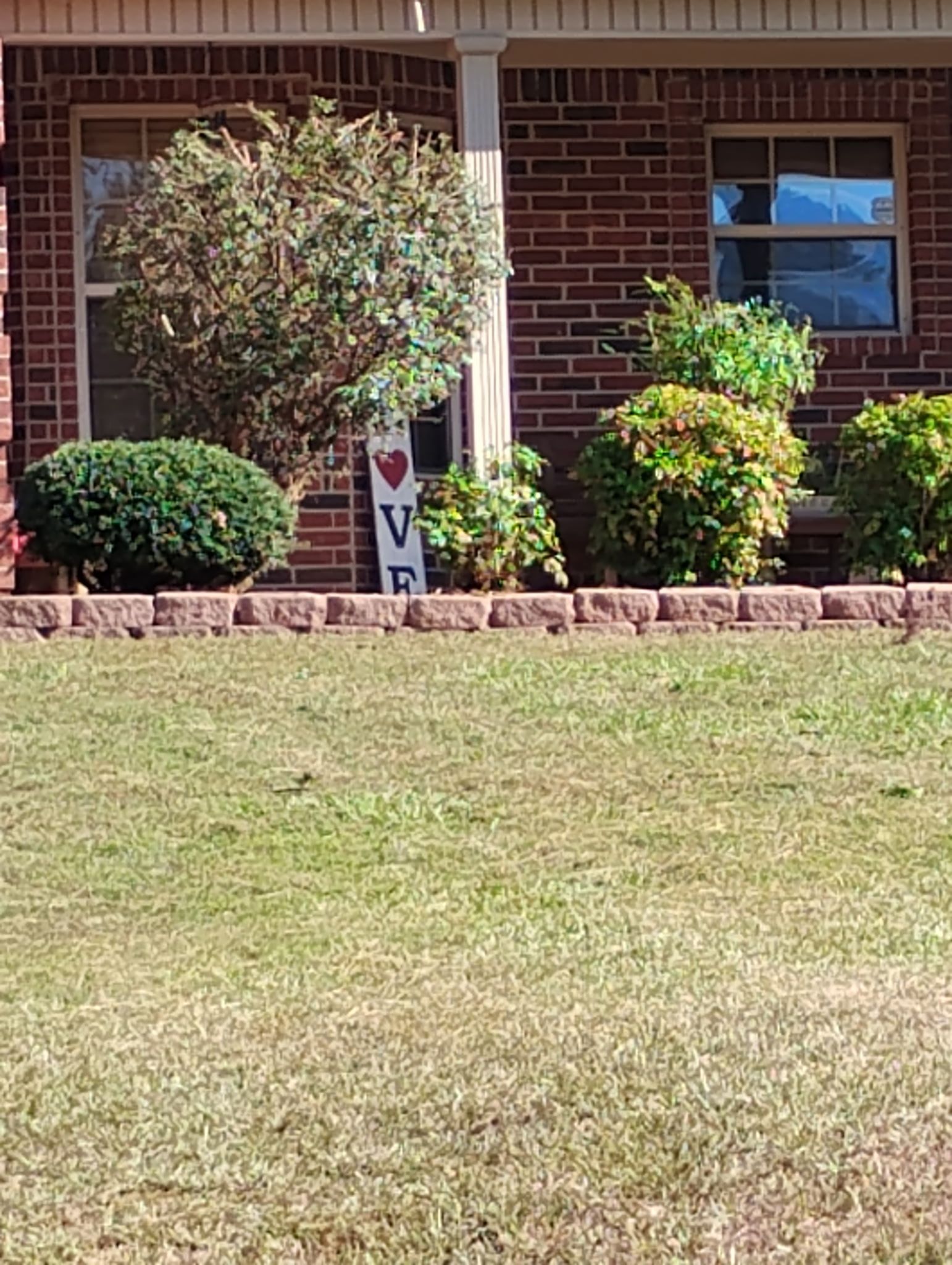 A brick house with a sign that says