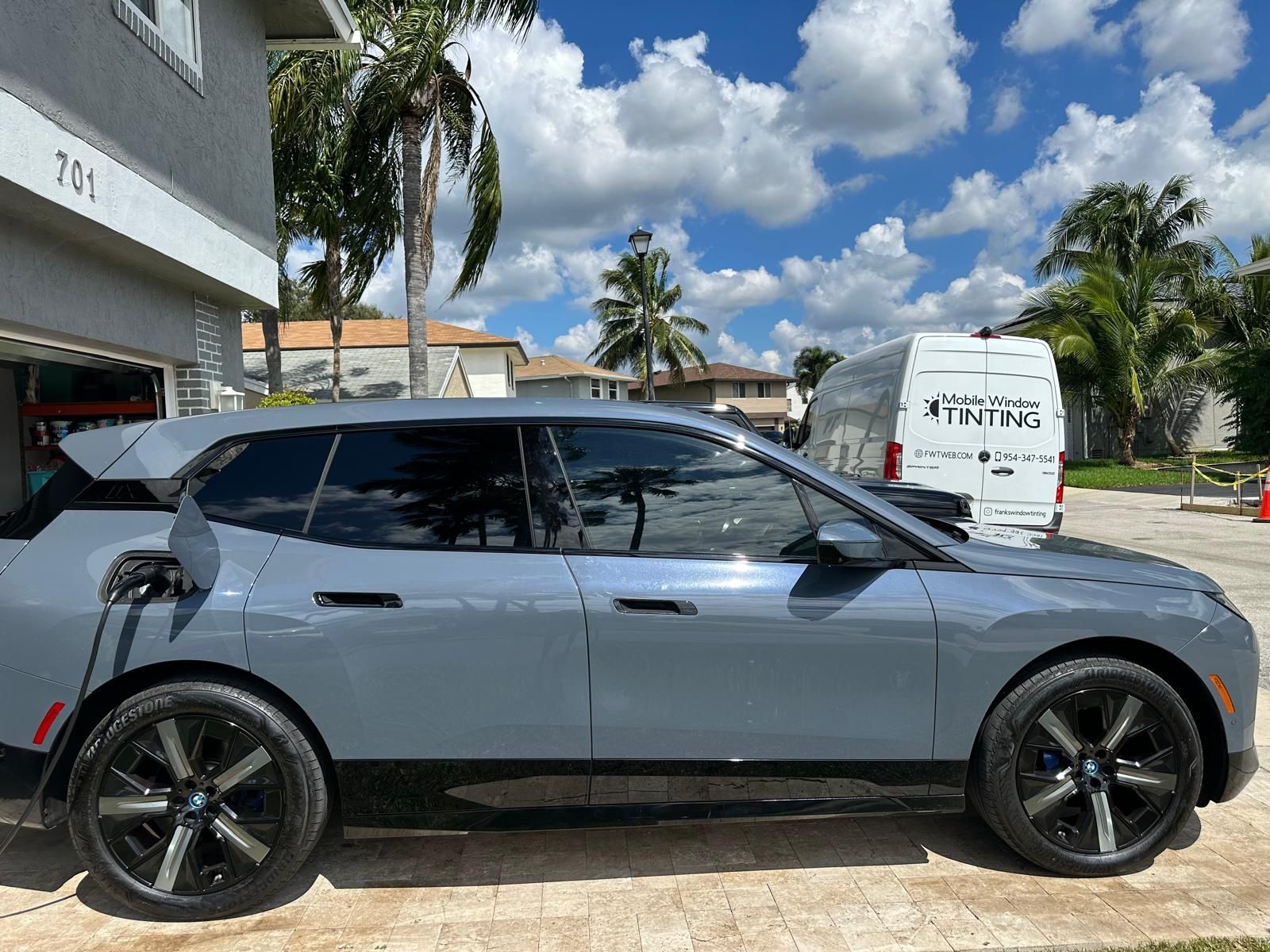 A bmw i8 is being charged in a garage.