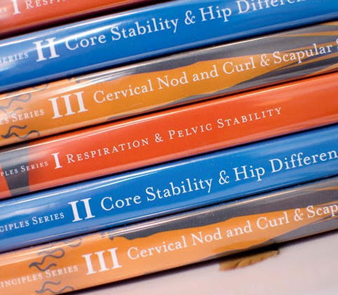 A stack of books titled core stability and hip difference