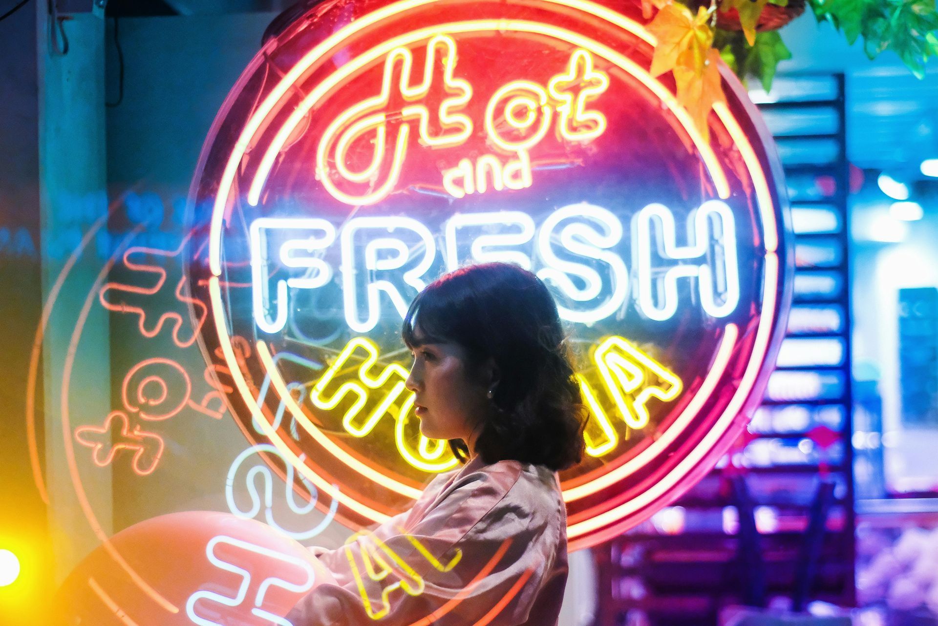 Woman in front of a neon sign that reads