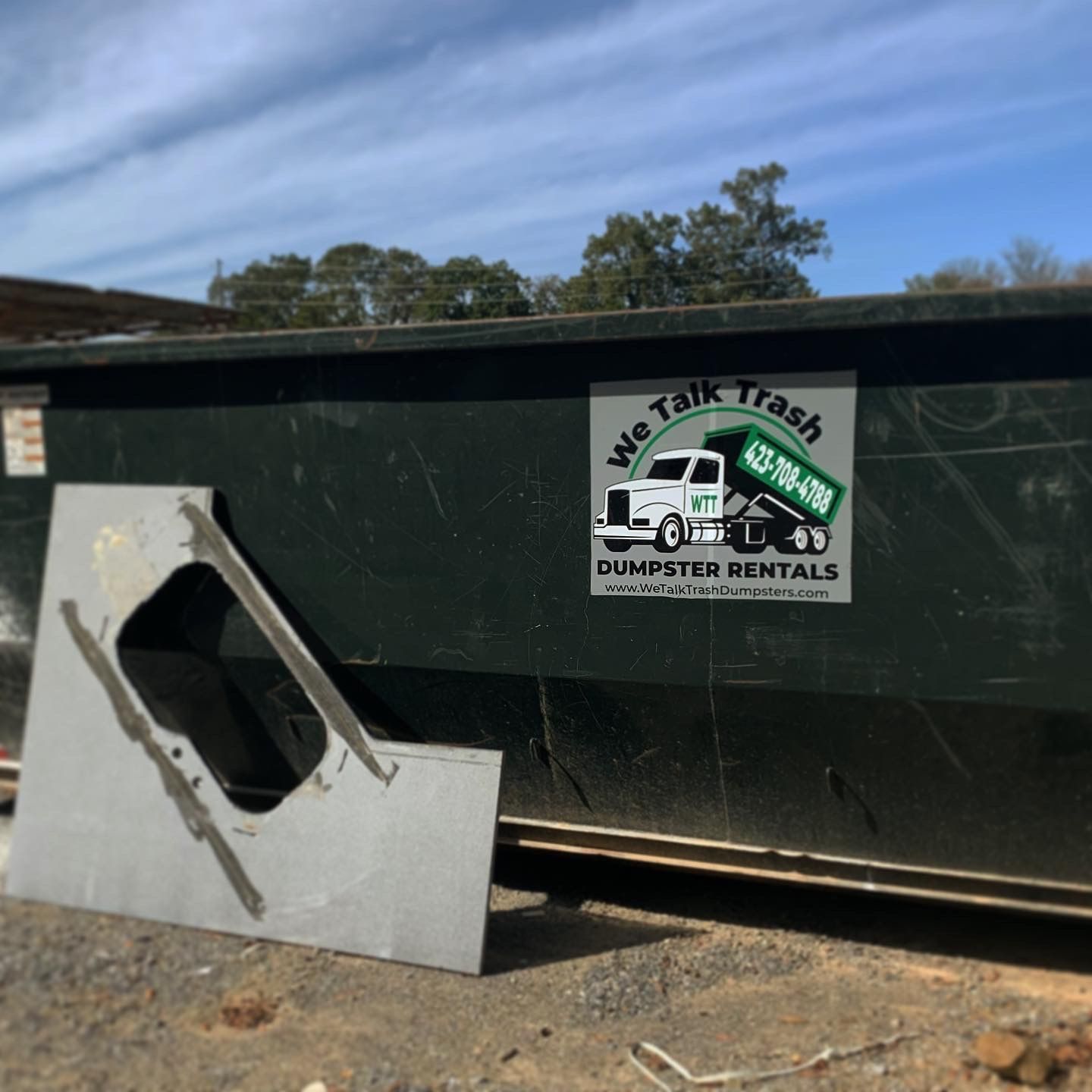 A dumpster with a sign that says we talk trash dumpsters rentals