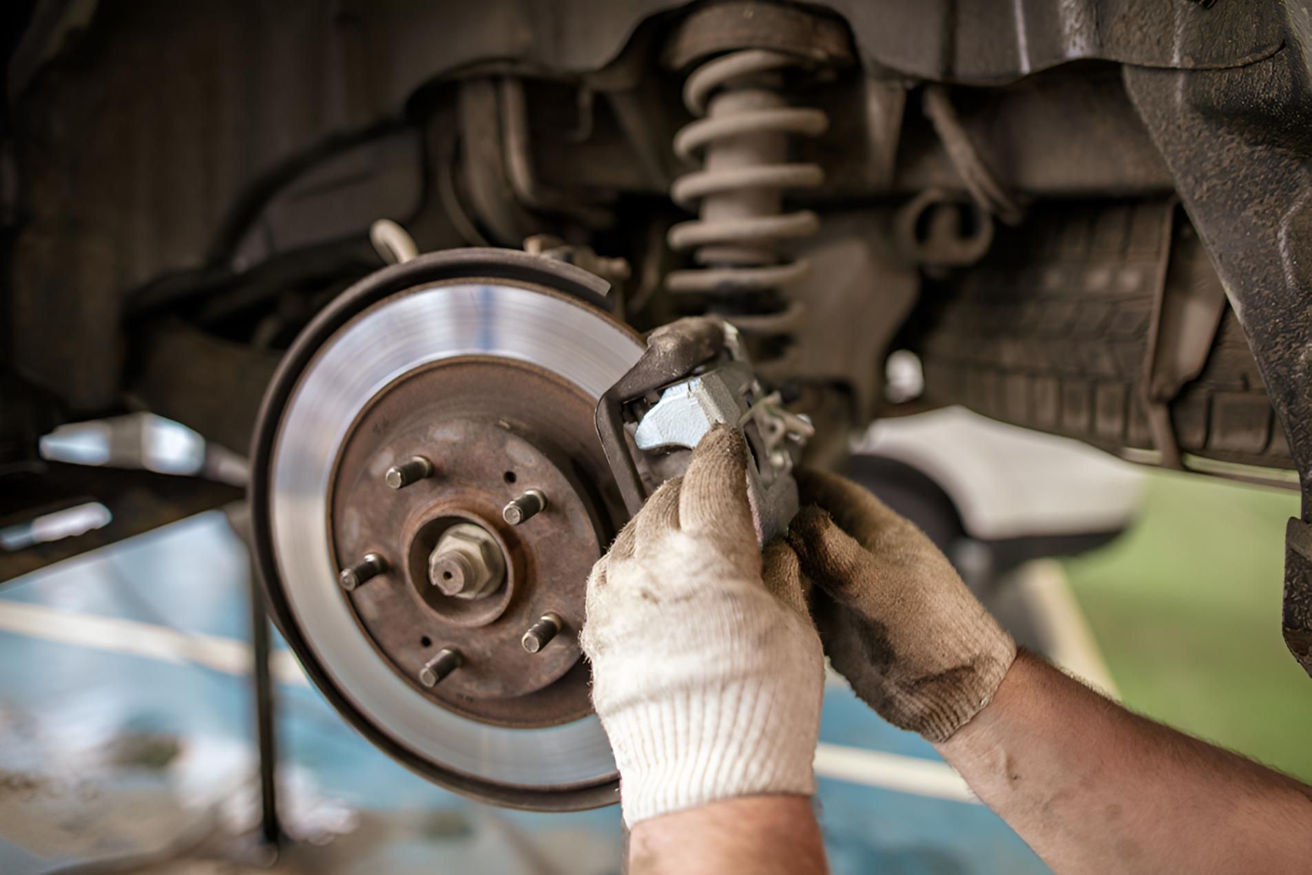 Person is Working on a Brake Disc on a Car — Noosa Mechanical in Noosaville, QLD