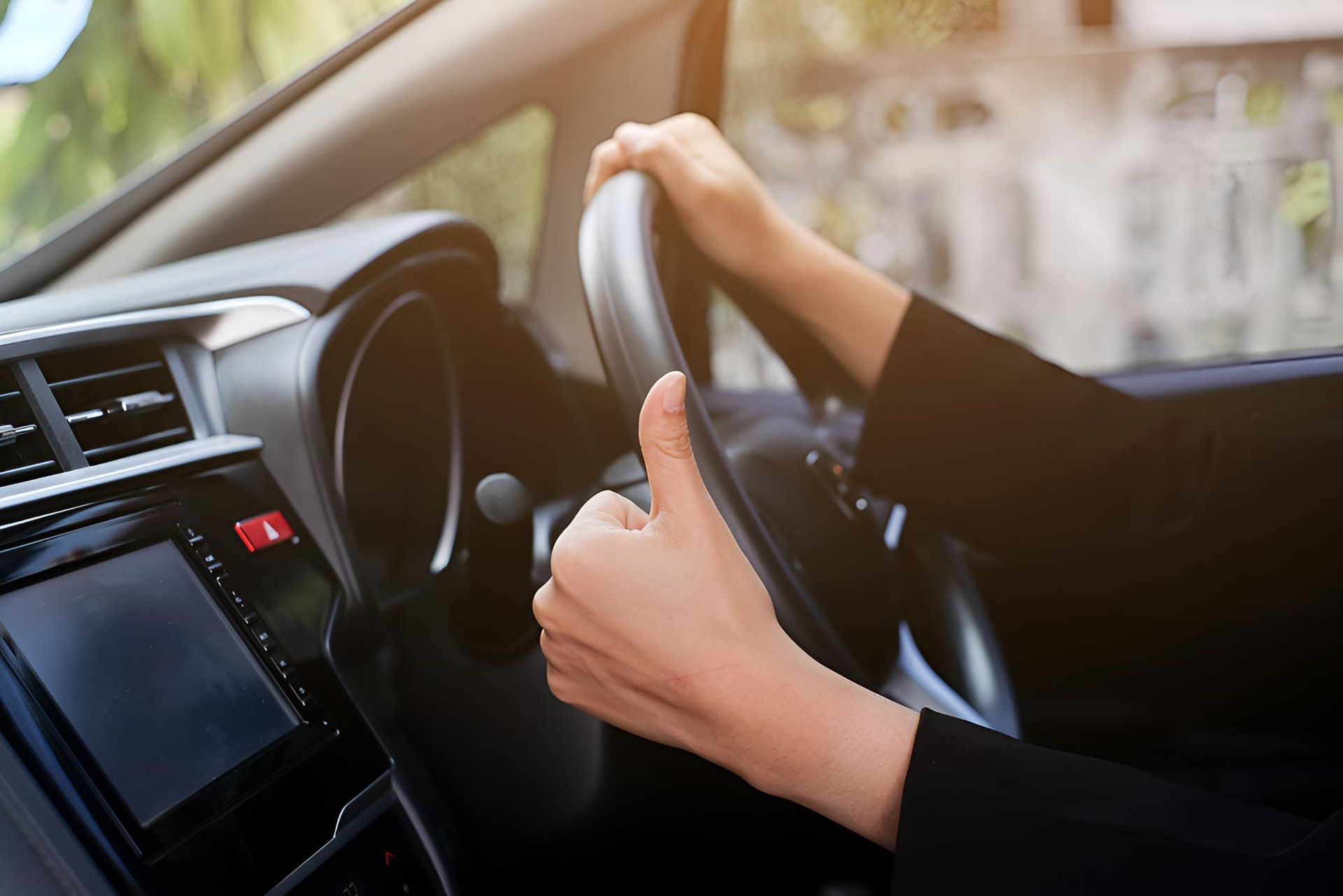Woman is Giving a Thumbs Up While Driving a Car — Noosa Mechanical in Noosaville, QLD