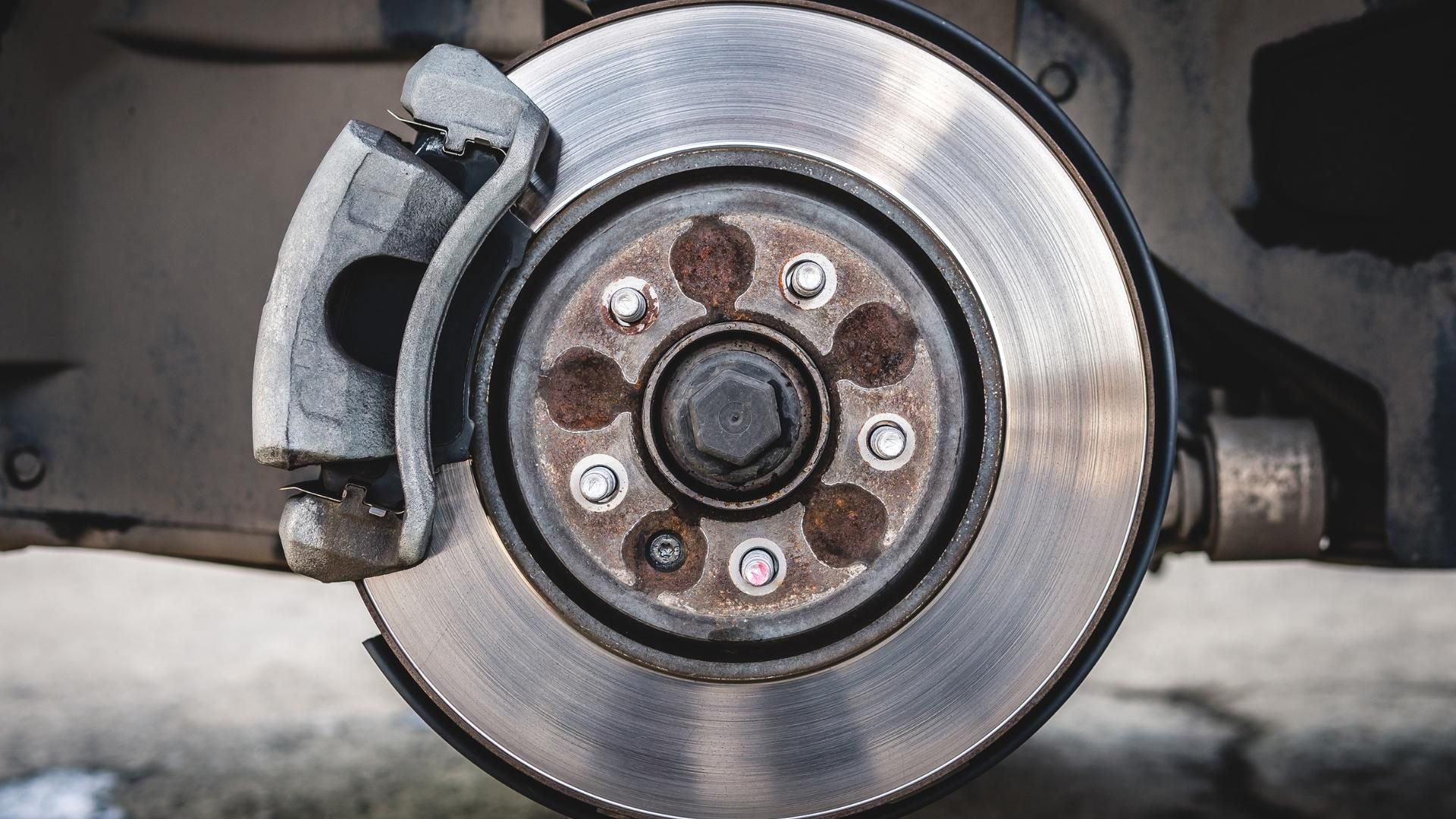 A close up of a brake disc on a car.