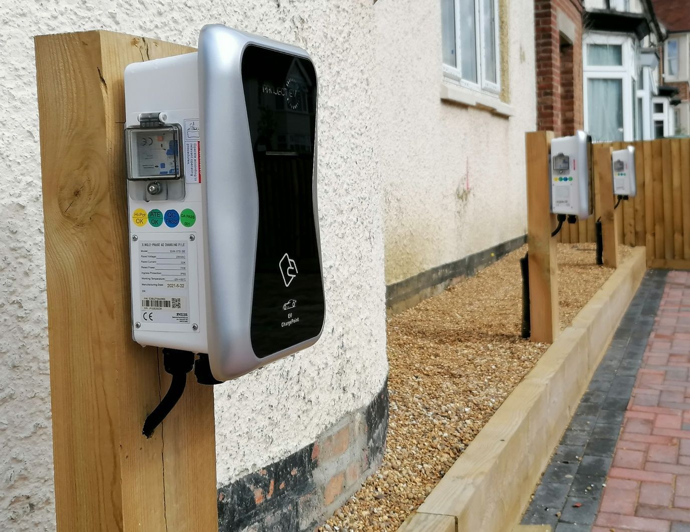 A row of charging stations are lined up outside of a house