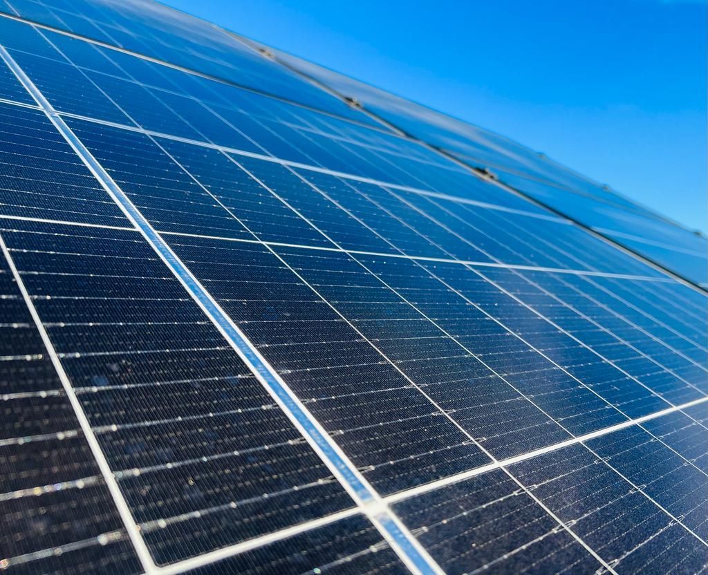 A close up of a solar panel with a blue sky in the background