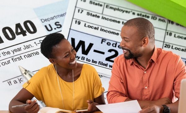 Couple successfully organizing taxes with professional guidance