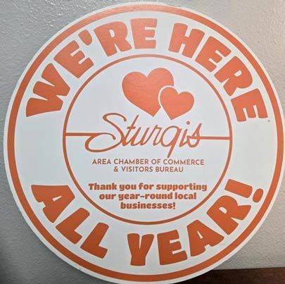 Round orange and white sticker: